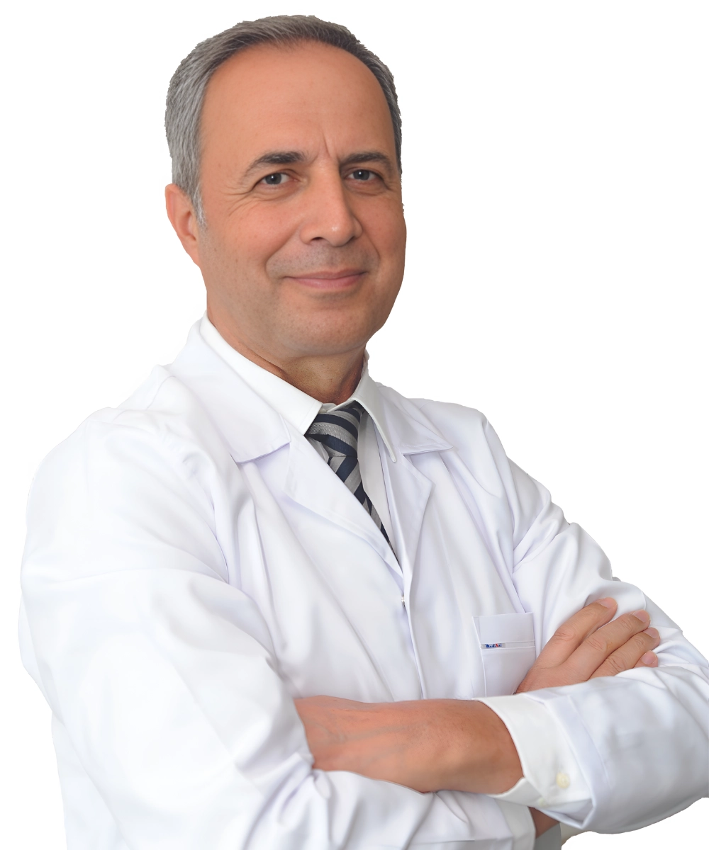 Portrait of Op. Dr. Ergün Erdoğan, a specialist in Ear, Nose, and Throat (ENT) diseases, standing confidently in a medical setting