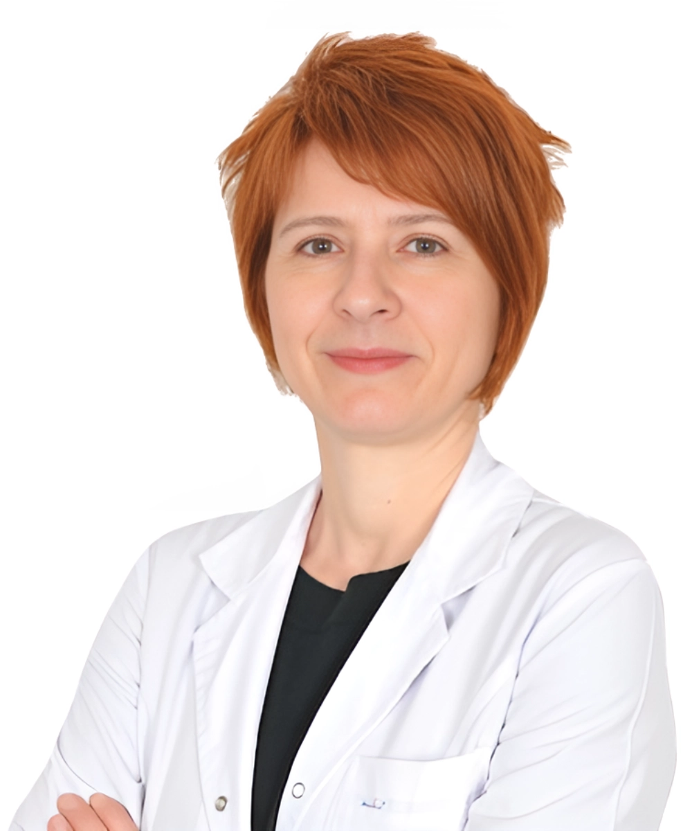 Portrait of Op. Dr. Şefika Aksoy, a Breast Surgery Specialist, standing confidently in a medical setting.