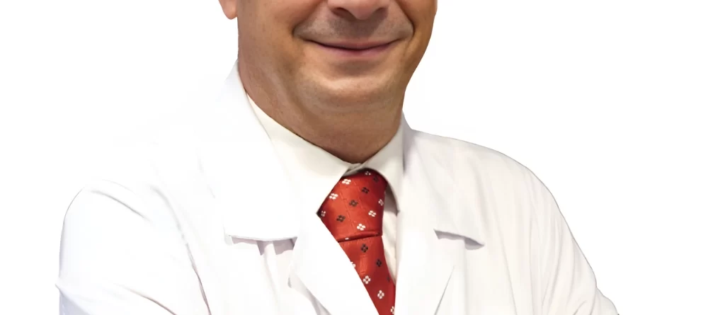 Portrait of Op. Dr. Zafer Gökhan Şermet, a General Surgery Specialist, standing in a medical setting.