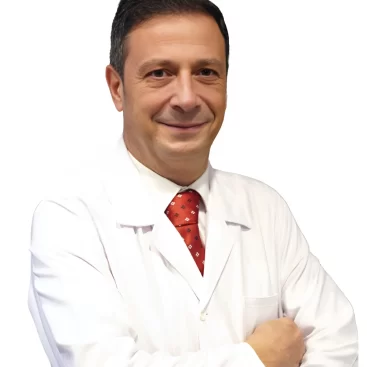 Portrait of Op. Dr. Zafer Gökhan Şermet, a General Surgery Specialist, standing in a medical setting.