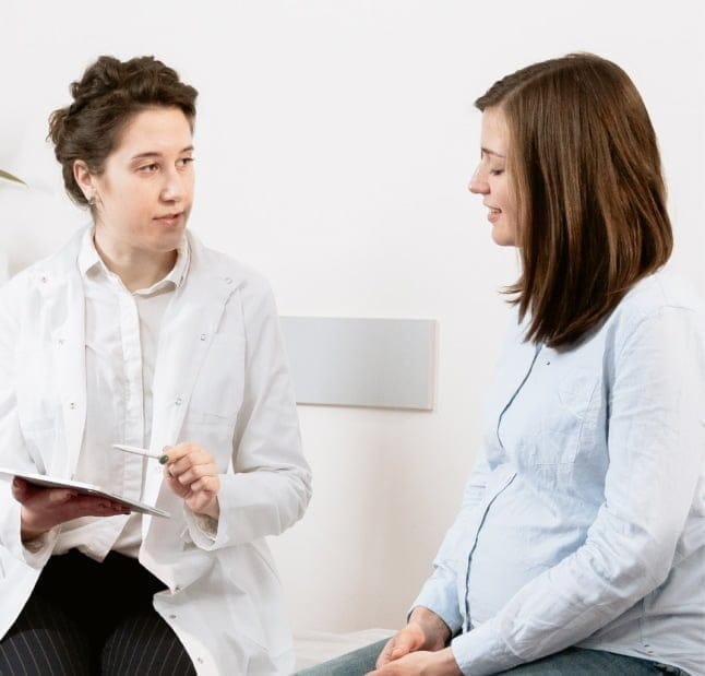 Dimple Creation Surgery: How Dimpleplasty Works A clinician in a white coat discussing a facial procedure with a patient during a consultation