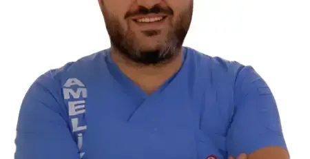 Portrait of Op. Dr. Erkan Yüce, a specialist in plastic, reconstructive, and aesthetic surgery, smiling confidently in a professional setting.