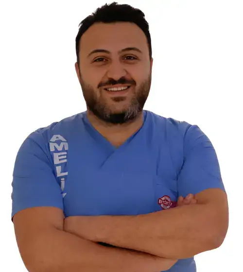 Portrait of Op. Dr. Erkan Yüce, a specialist in plastic, reconstructive, and aesthetic surgery, smiling confidently in a professional setting.