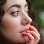 Woman with a small upturned nose, creating a youthful and feminine appearance.