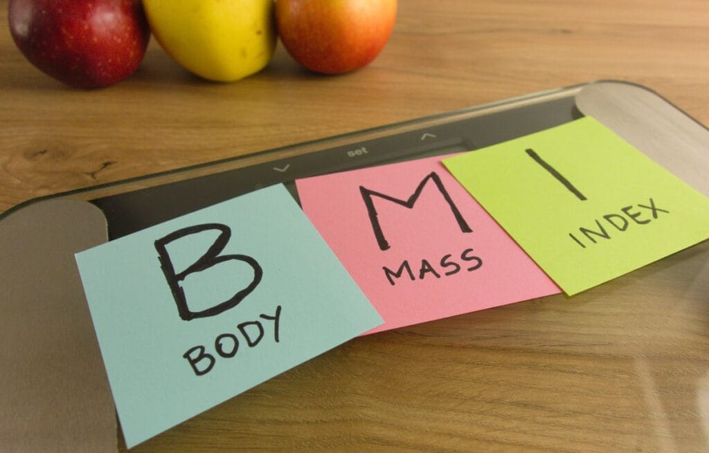 Healthy foods and exercise equipment to symbolize a healthy lifestyle for BMI management.